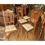 A set of five Arts and Crafts walnut Dining Chairs, each with central circular detailing to top