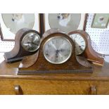 An early 20thC oak cased 'Napoleon Hat' Mantle Clock, 17½in (44cm) wide, together with two other '