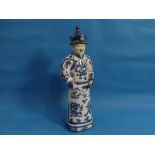 A 20th century Chinese blue and white porcelain figure of an Elder, behatted and holding a pipe, his