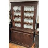 A late Victorian stained pine Bookcase, the base with a drawer above a pair of panelled doors,