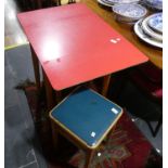 A vintage Remploy red formica drop-leaf Table, together with three stools (4)