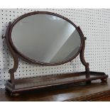 A Georgian mahogany Dressing Table Mirror, the large oval plate on swivel action arms and large