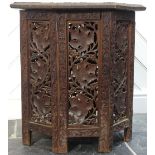 An early 20thC oak octagonal Side Table, the octagonal top with heavily incised decoration, raised