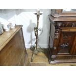 An early 20thC ecclesiastical brass Candlestick, the scrolled and twisted legs, with central brass