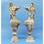 A pair of early 20thC marbled Ewers, the body with foliate decoration in high relief, stood on