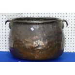A large early 20thC copper Cauldron, the beaten copper body with scrolled handles, 21in (53cm)