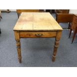 A vintage pine Kitchen Table, the planked top above central frieze drawer, raised on turned legs,