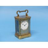 An early 20th century French gilt brass Carriage Clock, of five glass form with hinged carry handle,