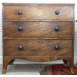 A Georgian mahogany Chest of Drawers, the three long drawers with turned handles, graduated in size,
