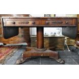 A Regency rosewood Sofa Table, the table with drop-flap ends and bead moulded edge, on two frieze