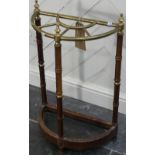An early 20thC brass and mahogany Stick Stand, the fan-shaped brass top raised on mahogany and brass