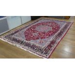 Tribal Rugs; a hand-knotted wool Persian carpet, red ground with blue border and central