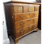 An early Georgian walnut Chest of Drawers, the cross-banded top with feathering border, above