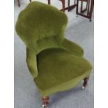 An early 20thC Nursing Chair, the button back above stuff-over seat, all in green upholstery, raised