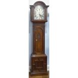 An early 20th century oak 8-day Longcase Clock, the arched silvered 13in (33cm) dial with black