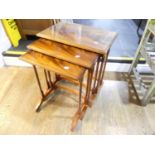 An early 20thC flame mahogany Nest of Tables, the largest of the three with glass topper, all raised