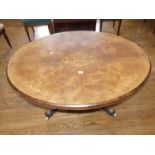 A late Victorian walnut oval Breakfast Table, the quarter veneered top with floral marquetry
