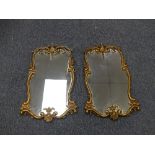 A pair of Rococco-style Wall Mirrors, in typical Rococco style swag and foliate gilt frames, 25in (