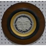 A Wedgwood Jasperware 'Medusa' Plaque, in dark blue ground, and circular mount, framed and glazed,