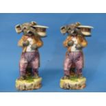 A pair of early 20th century pottery 'Elephant' Candlesticks, modelled standing in top hat and tails