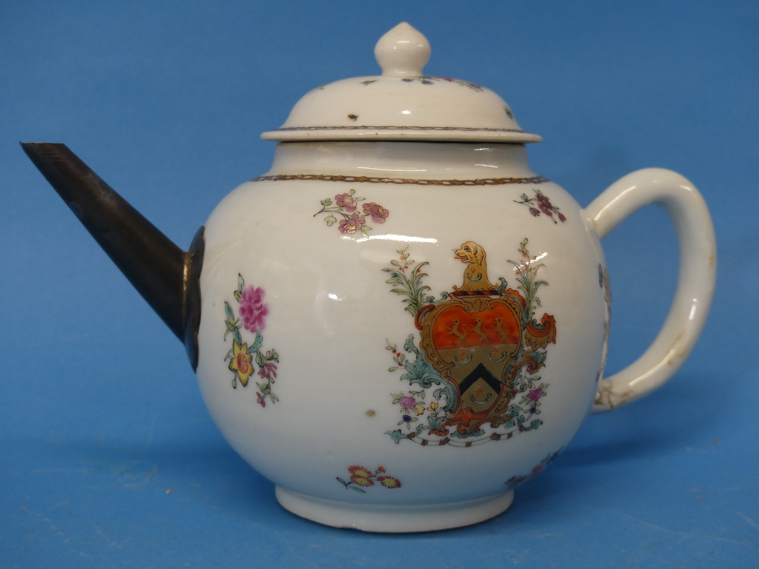 An 18thC Chinese Export Armorial Teapot, decorated in floral sprays with central crest and gilded