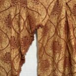 A pair of lined Curtains, with swags and tails, in dark rust
