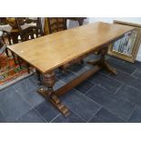 A Carolean style oak refectory Table, the rectangular top raised on a trestle base with baluster