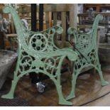 A pair of Victorian green-painted cast iron Bench Ends, with central lion mask motif, with