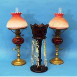A pair of early 20thC Cranberry and pink Glass Oil Lamps, by Zimmerman & Co of London, with an