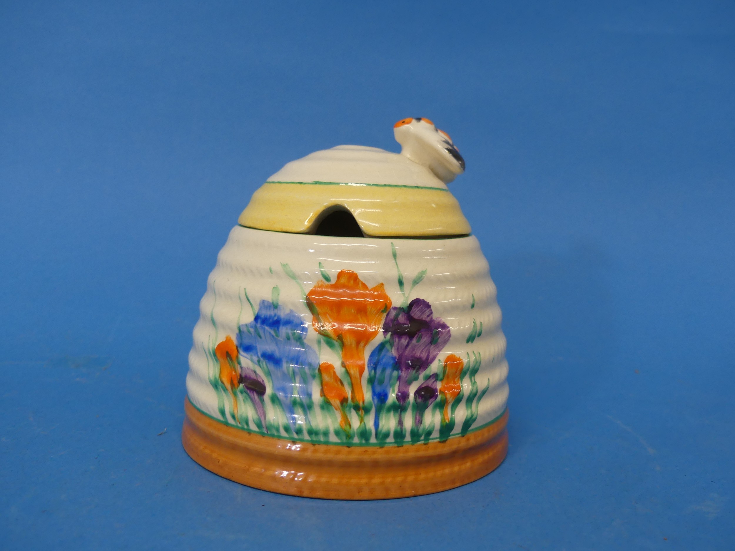 An early 20thC Clarice Cliff Newport Pottery 'Spring Crocus' pattern Honey Pot, with bee finial,