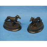 A pair of spelter Greyhound figures, raised upon plinths, 8in (20cm) wide (2)