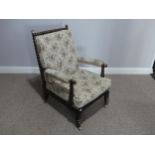 A Victorian ebonized wood and upholstered Armchair, with bobbin turned spindles, supports and