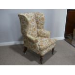 A Victorian mahogany wing Armchair, the upholstered back with lugged sides and outscrolled arms,
