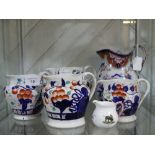 Set of four graduated Staffordshire Jugs, decorated in the imari palette, together with Large