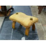 A vintage Camel Saddle/stool, with leather cushion seat, brass mounts and studs.