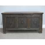An antique oak Coffer, the three panel front each with an applied central flower motif, the interior