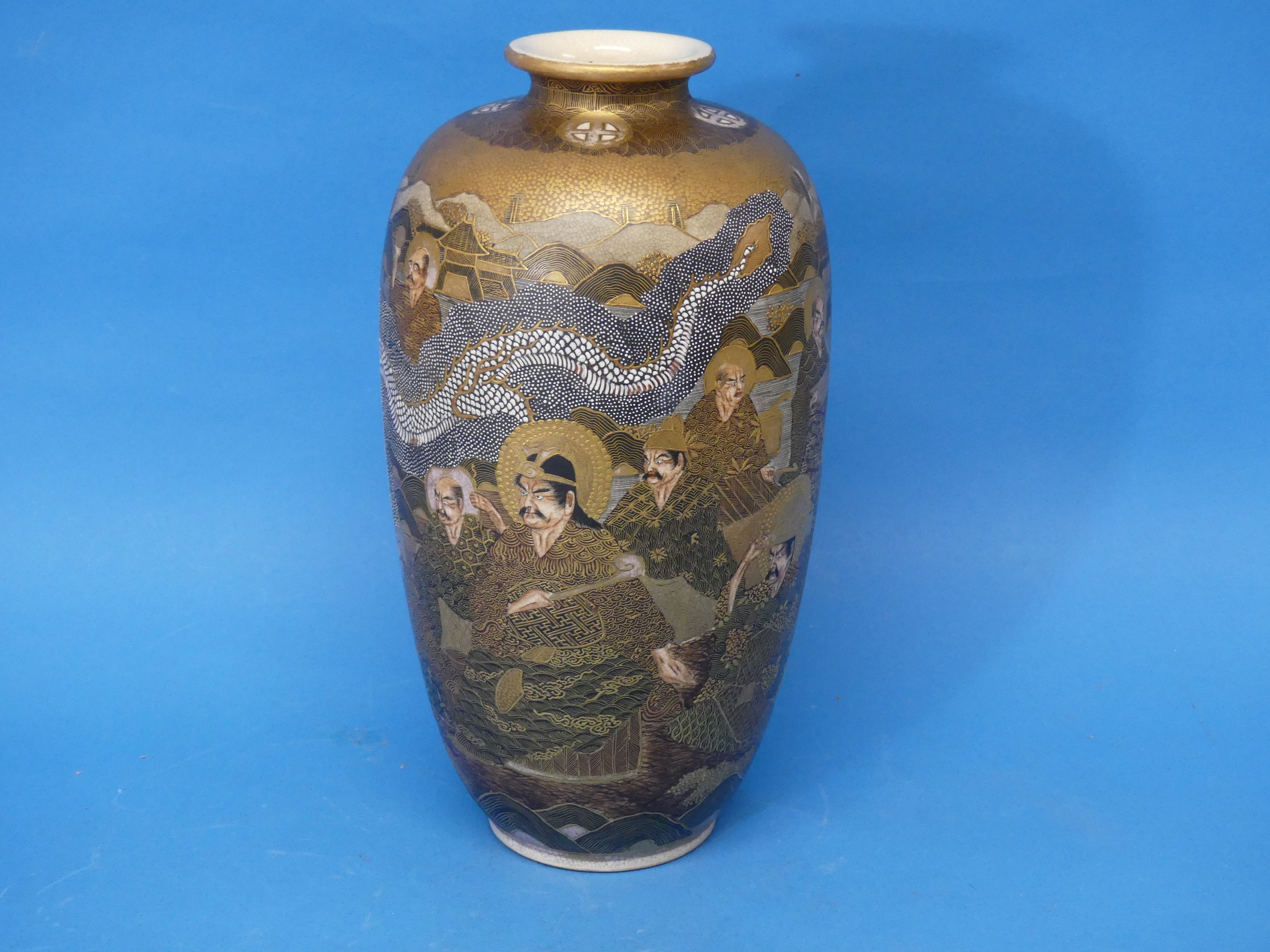 An early 20thC Japanese Satsuma Vase, depicting characters' faces, dragons and temples, with a