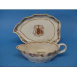 An 18thC Chinese Export Armorial Porcelain Sauce Boat and Saucer, bearing the crest of the