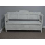 A vintage white-painted pine box Settle, with three panel scroll back and hinged seat, 72in (