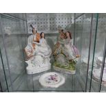 A pair of 19thC Staffordshire Flat Backs, both depicting a pair sat upon a clock, together with a