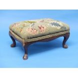 A small Victorian mahogany framed Foot Stool, the tapestry work stuff-over seat raised on pad