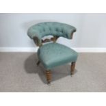 A Victorian mahogany library Chair, with carved mid-rail, horseshoe shaped buttoned back and