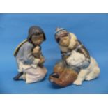 A Lladro figure of an Inuit Girl, depicted with a dog, 9in (23cm) high, together with another Lladro