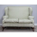 An early 20thC Howard & Son two seat wing-back Sofa, stamped on one rear leg '7854 3105 Howard &