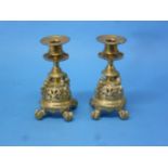 A pair of 19thC brass Candlesticks, with four mythical beasts and pierced decoration, raised on four