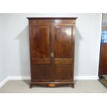 An Edwardian mahogany Wardrobe, with panelled doors, boxwood stringing and shell inlay, on bracket