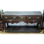 An early 19th century oak Dresser Base, the rectangular top above five drawers with brass handles,