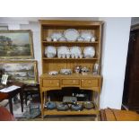 A modern light oak Dresser, the base with three short drawers above a low shelf, two shelf rack