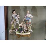 A Sitzendorf porcelain figural Group, depicting children picking grapes, mounted on gilt metal