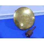 An antique brass Gong, incised profusely with decoration, 12in (30cm) diameter, together with a